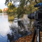 Film Camera set up in front of a body of water