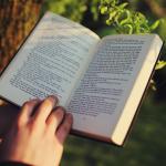 An open book being held with two hands