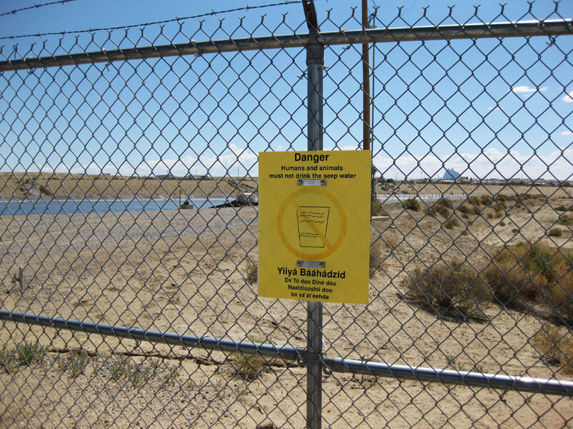 Warning Sign posted on a fence. 