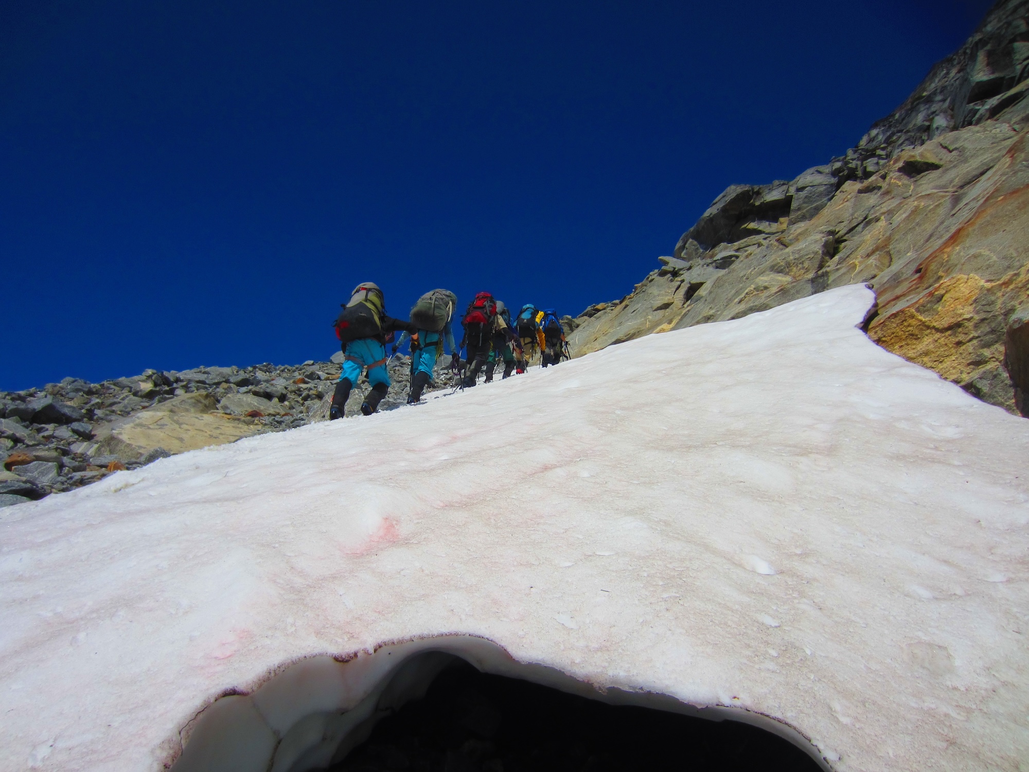 Scientists walk up ice and snow