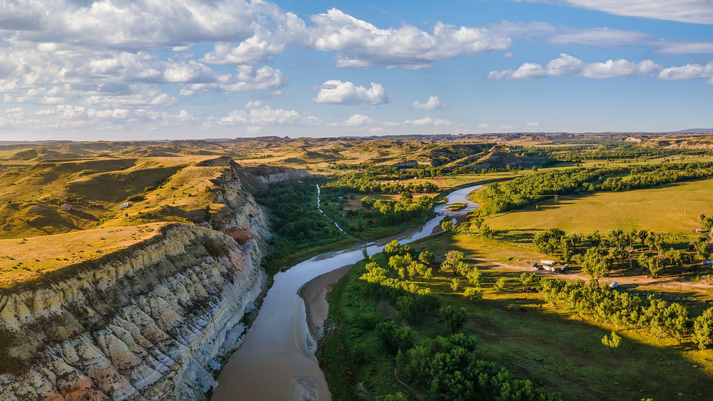 River in a valley surrounded with green cliffs