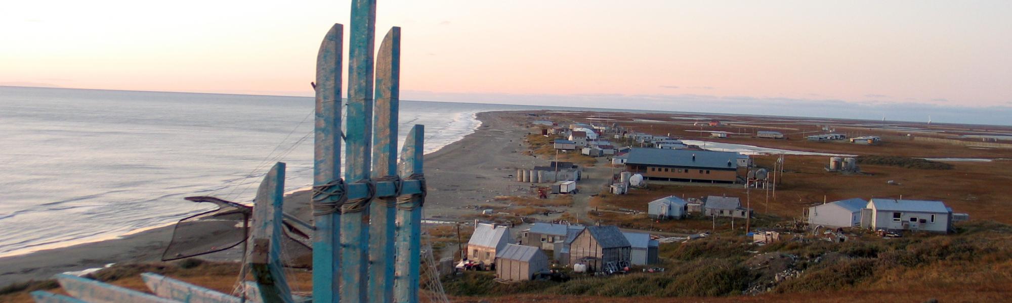 Ocean town with houses on the shore during sunset