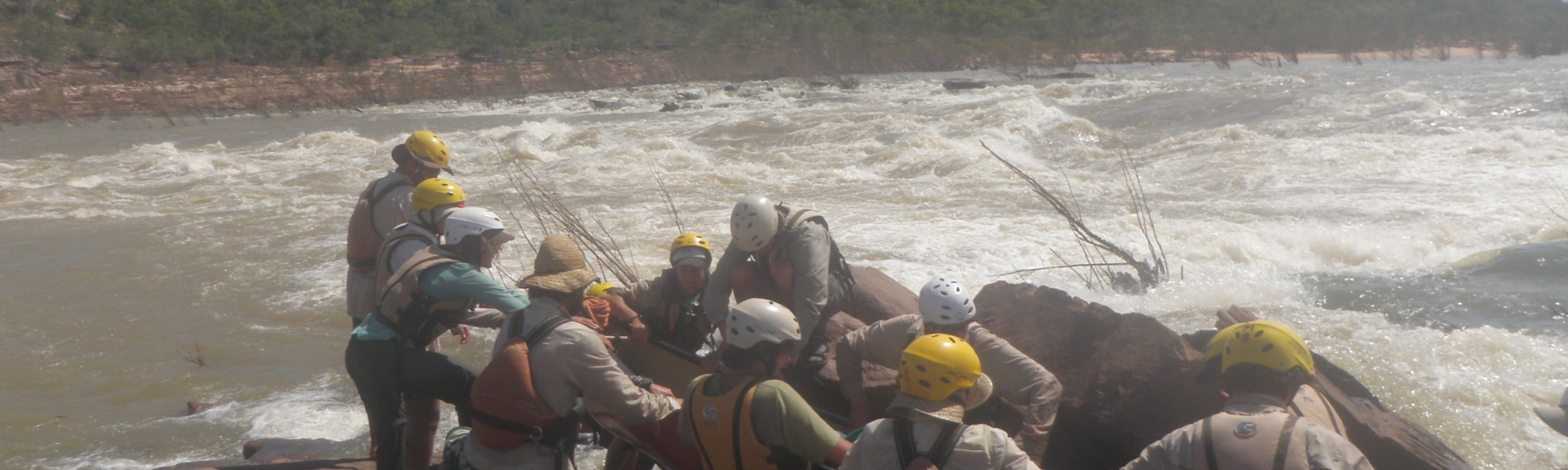 Field group working together to navigate river rafting