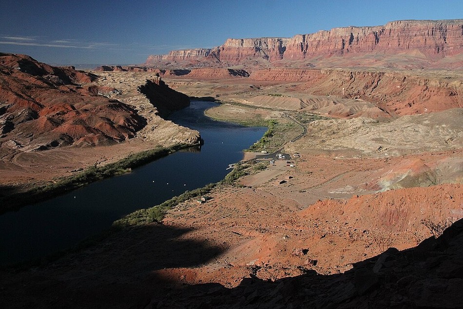 Colorado River, Lee's Ferry. Red plateau landscape with the colorado running through and a road leading to a boat launch