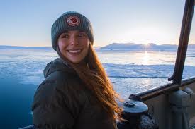 Lianna Nixon smiles over her shoulder wearing winter gear in the Antarctic