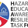 A circular logo cut into fourths with a fire symbol in red, a sun thermometer symbol in orange, a plant in yellow, and a house flooded in blue. The words, "Hazard Education Awareness & Resilience Task Force" are to the right of the circle. 