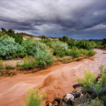 A flooding river with dark clouds 