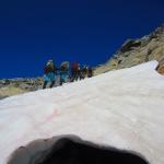 Scientists in the field, hiking up a mountain