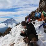 Scientist conducting  research on a snowy mountain cliff