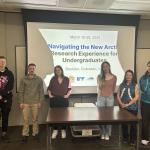 NNA students from 2025 standing in front of a powerpoint after giving their presentations