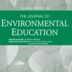 Cover of "The Journal of Environmental Education," Volume 52, Number 4, 2021. The background features a faint, grayscale image of leaves, symbolizing nature and environmental focus. The title is prominently displayed in large white capital letters on a green background. Below the title, the editor-in-chief is listed as Alberto Arenas, and the executive editors are Beth A. Covitt, Paul Hart, and Hilary Whitehouse.