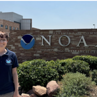 Leah standing in front of NOAA building 