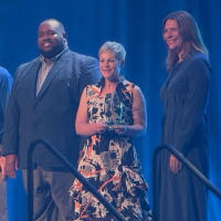 Carrie McDougall stands on stage with peers and award presenters at the ASTC Award Ceremony as she is presented with her trophy celebrating her achievement.
