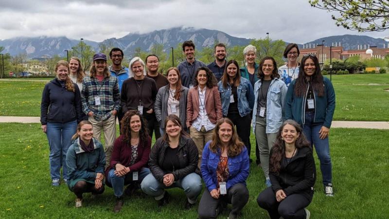 Group of people standing together outside smiling for the camera