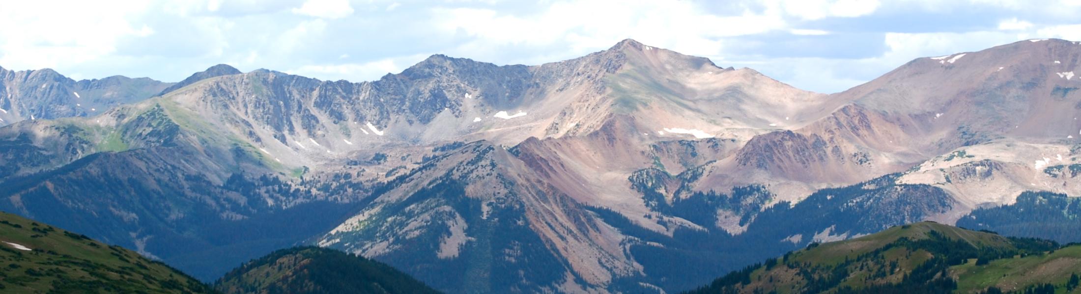 mountain peaks with very small patches of snow