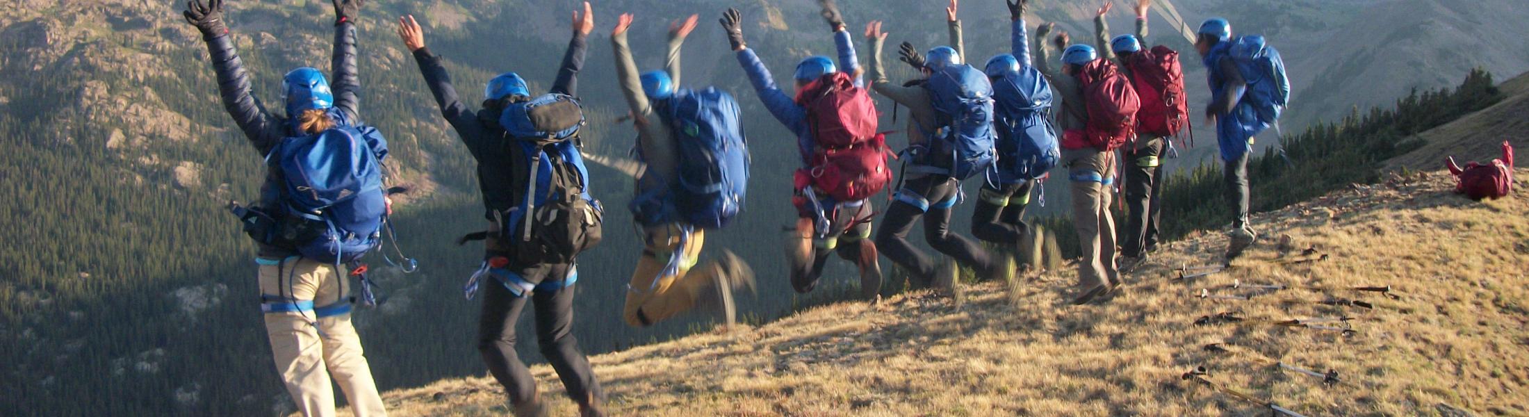 Backpacking participants jumping