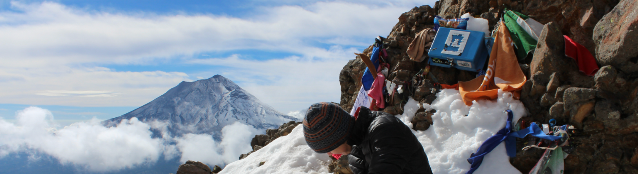 Researcher writing on a mountain side