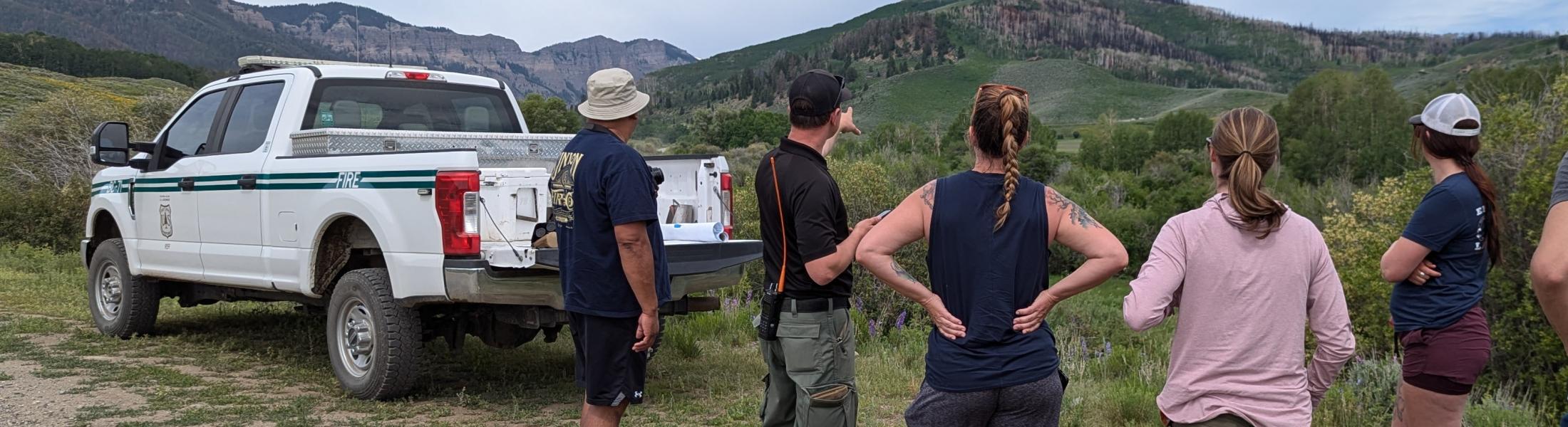 teachers view a wildfire burn scar with a forest service fire management officer