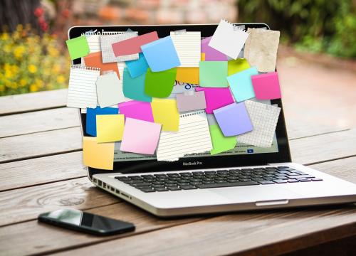 Computer covered in post-it notes