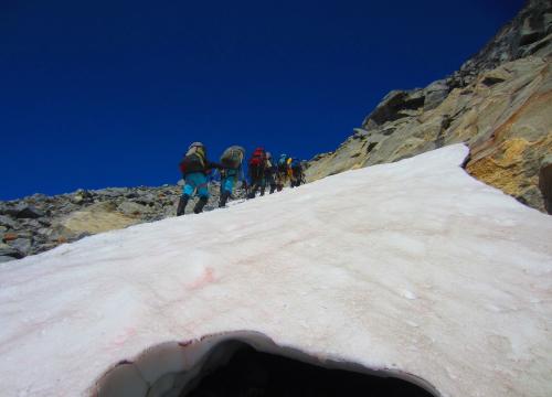 Scientists walk up ice and snow