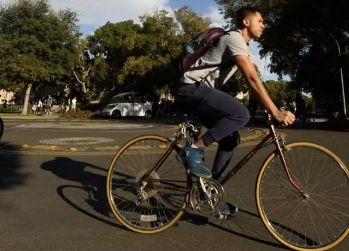 a photo of a man riding a bicycle on the road 