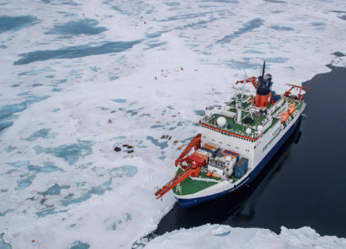 Seen from the air the Polarstern floats alongside the MOSAiC ice floe