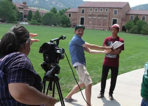 Group of students with a camera and equipment filming 