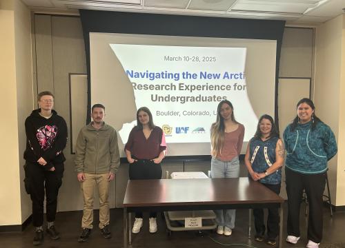 NNA students from 2025 standing in front of a powerpoint after giving their presentations