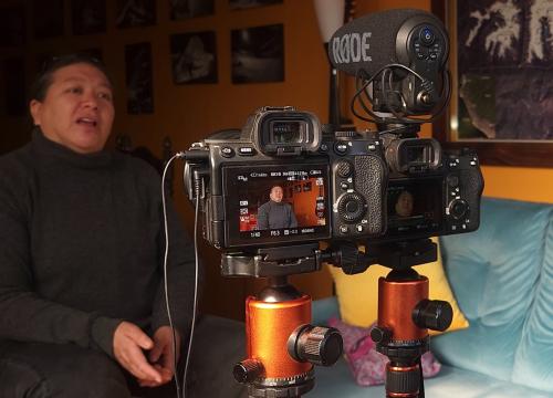 Ryan Vachon recording a women in her home