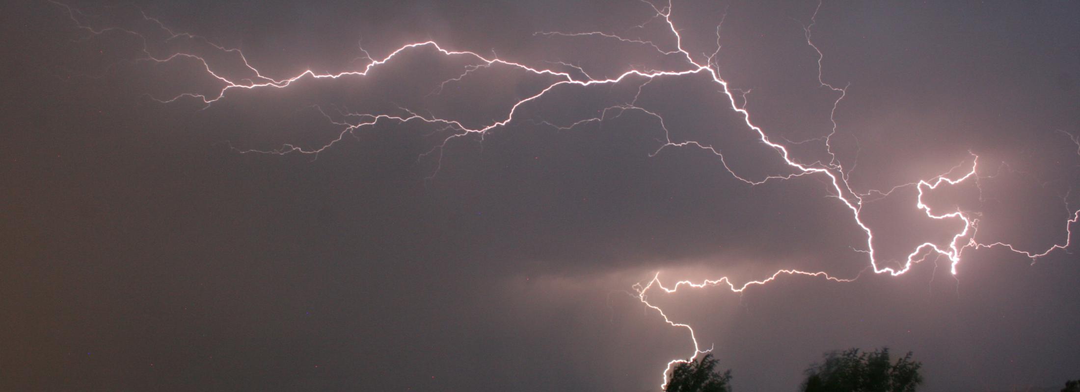 large bolt of lightning across night sky