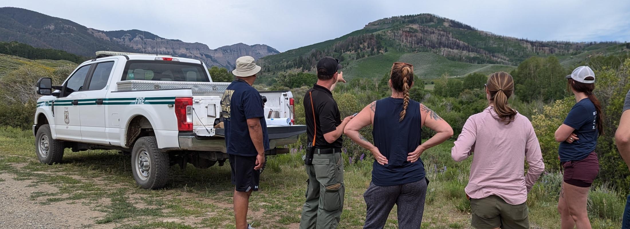 teachers view a wildfire burn scar with a forest service fire management officer