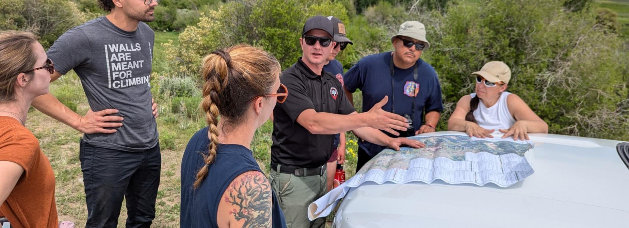 HEART Force Teacher Fellows, HEART Force and Earth Force Program Managers, learn about the 2023 Lowline Fire on a field trip with Gunnison Ranger District Assistant Fire Management Office, Theo Engel. 