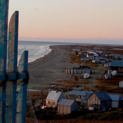 Ocean town with houses on the shore during sunset