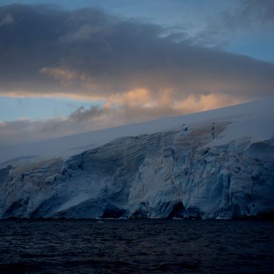 Ice berg and ocean at sunset