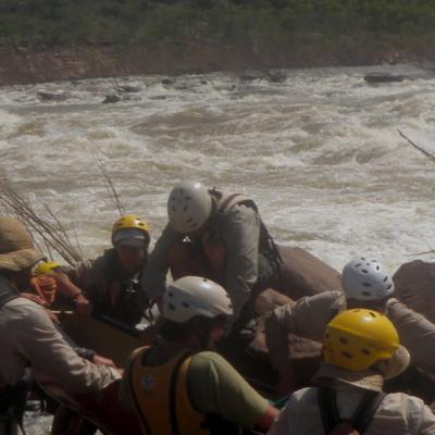 Field group working together to navigate river rafting