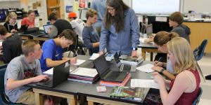 Educator in a classroom teaching 4 kids