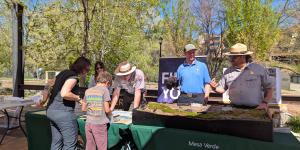 People at a table with park rangers