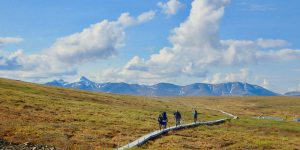 People hiking in Colorado headed west to the mountains on a built out bridge trail