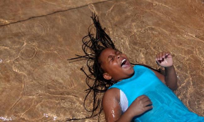 Trelynn Watkins, 10, laughs as she plays in the Julia Primrose Fountain.