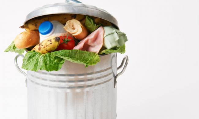 A trash can overflowing with food.