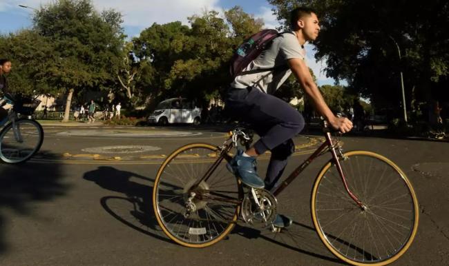 a photo of a man riding a bicycle on the road 