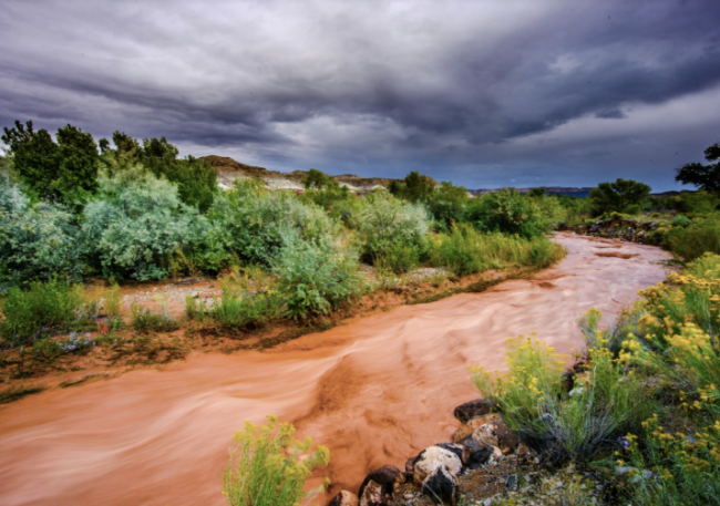 A flooding river with dark clouds 