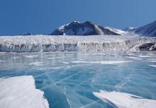 iced over lake and mountains