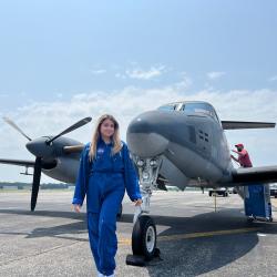 This is a picture of Karla in front of an airplane