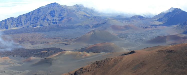 Landscape with mountains in background, scattered hills in foreground